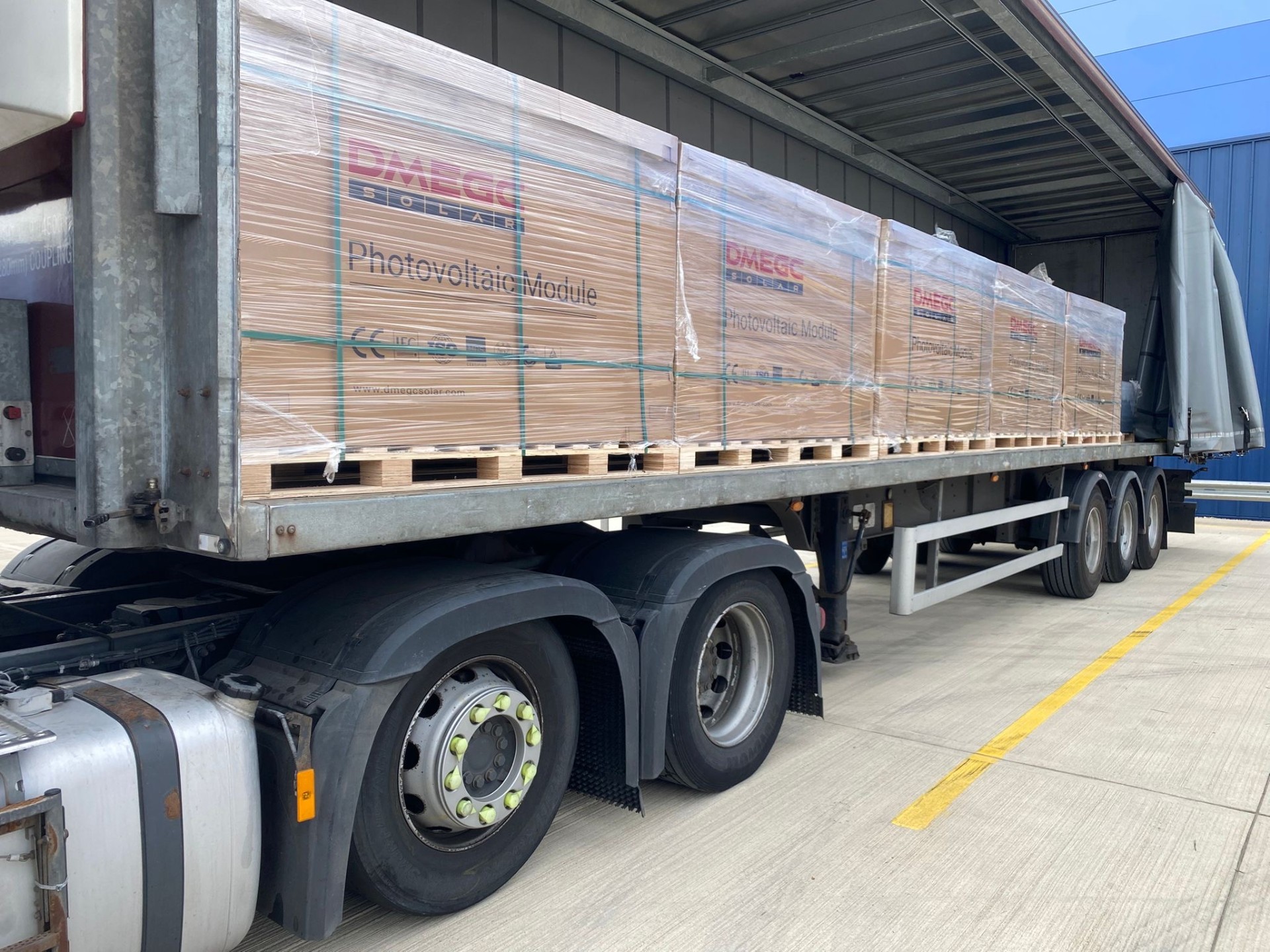 Curtain-side trailer loaded with solar PV modules